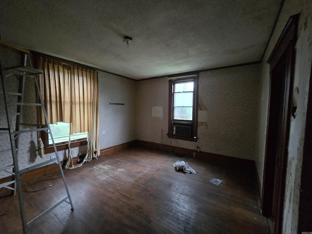 1609 W Charles Bussey Ave, Little Rock, AR 72202 - empty room with a textured ceiling, wood finished floors, wallpapered walls, baseboards, and cooling unit
