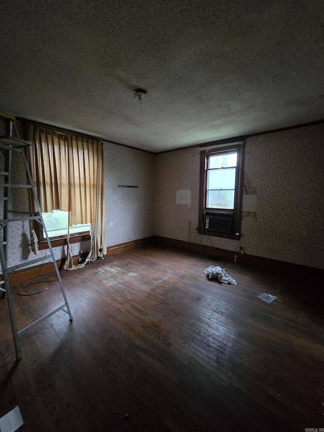 1609 W Charles Bussey Ave, Little Rock, AR 72202 - unfurnished room featuring wood finished floors, a textured ceiling, cooling unit, wallpapered walls, and baseboards