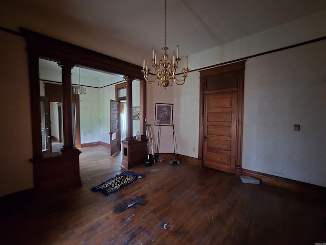 1609 W Charles Bussey Ave, Little Rock, AR 72202 - unfurnished dining area with a chandelier, wood-type flooring, decorative columns, and baseboards