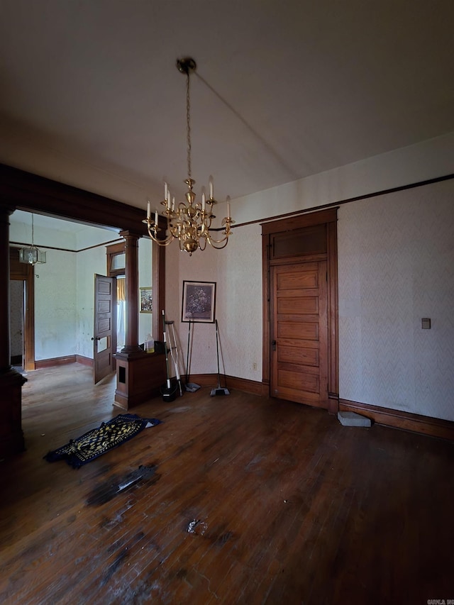 1609 W Charles Bussey Ave, Little Rock, AR 72202 - unfurnished dining area with a chandelier, ornate columns, hardwood / wood-style floors, and baseboards