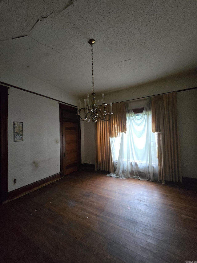 1609 W Charles Bussey Ave, Little Rock, AR 72202 - empty room with a chandelier, wood finished floors, and a textured ceiling