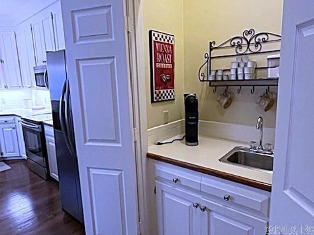 2111 Hinson Rd Unit 19, Little Rock, AR 72212 - kitchen with range with electric cooktop, a sink, stainless steel microwave, dark wood finished floors, and light countertops