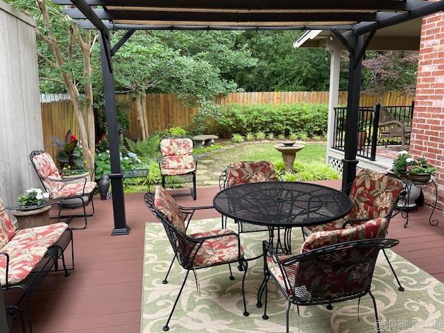 2111 Hinson Rd Unit 19, Little Rock, AR 72212 - fenced backyard with a deck, a pergola, and outdoor dining area