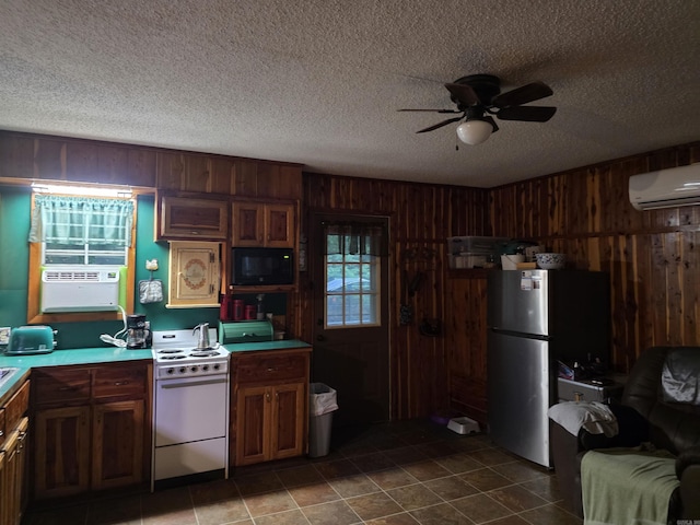 249 Mud Cat Rd, Heber Springs, AR 72543 - kitchen featuring white range with electric stovetop, freestanding refrigerator, black microwave, a wall mounted air conditioner, and wood walls