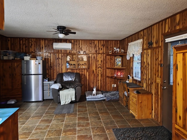 249 Mud Cat Rd, Heber Springs, AR 72543 - sitting room with a wall mounted air conditioner, ceiling fan, wooden walls, and a textured ceiling