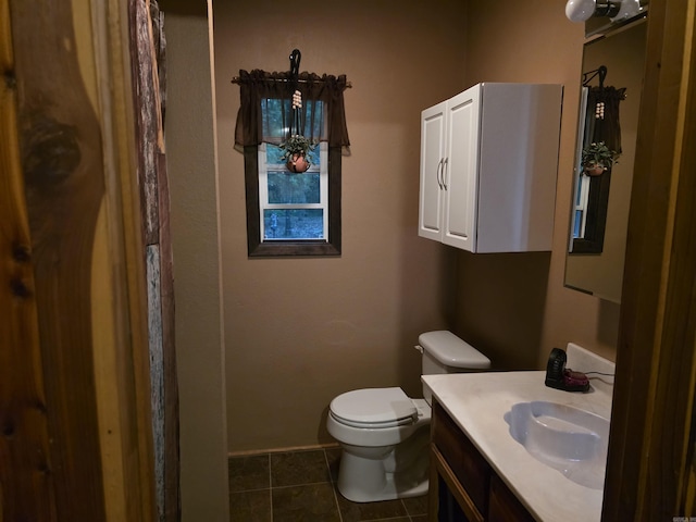 249 Mud Cat Rd, Heber Springs, AR 72543 - bathroom with toilet, vanity, tile patterned floors, and baseboards