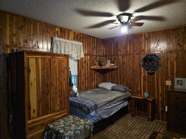 249 Mud Cat Rd, Heber Springs, AR 72543 - bedroom featuring wooden walls, a textured ceiling, and a ceiling fan