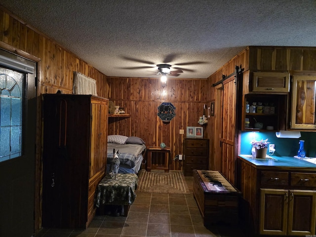 249 Mud Cat Rd, Heber Springs, AR 72543 - kitchen featuring wooden walls, a textured ceiling, a barn door, a ceiling fan, and open shelves