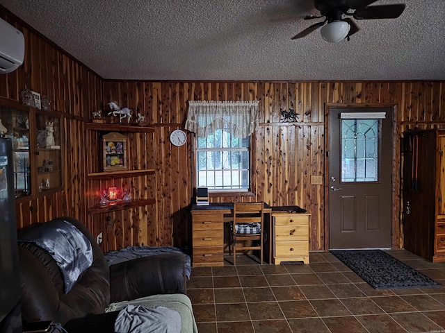 249 Mud Cat Rd, Heber Springs, AR 72543 - office with a textured ceiling, wood walls, a ceiling fan, a wall mounted AC, and dark tile patterned flooring
