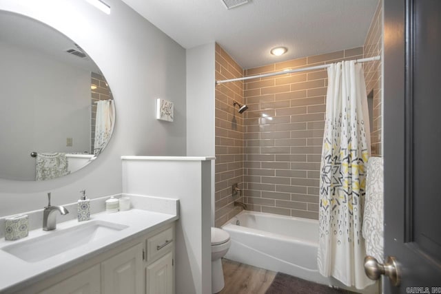 55 Laver Cir, Little Rock, AR 72210 - bathroom featuring vanity, toilet, wood finished floors, shower / bath combo with shower curtain, and a textured ceiling