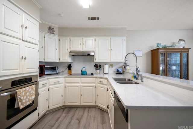 55 Laver Cir, Little Rock, AR 72210 - kitchen featuring appliances with stainless steel finishes, a sink, a peninsula, white cabinets, and light wood finished floors