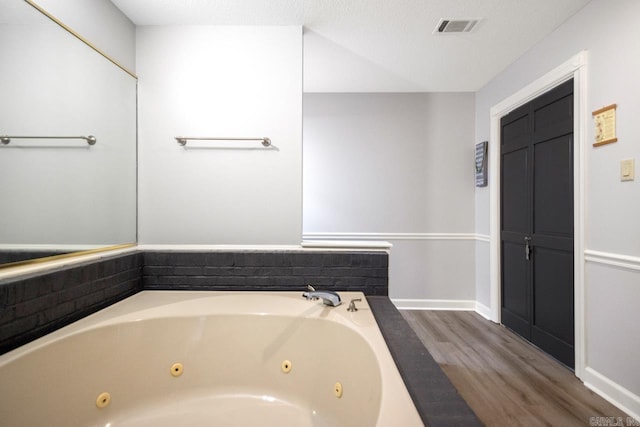55 Laver Cir, Little Rock, AR 72210 - full bathroom featuring a whirlpool tub, wood finished floors, and baseboards