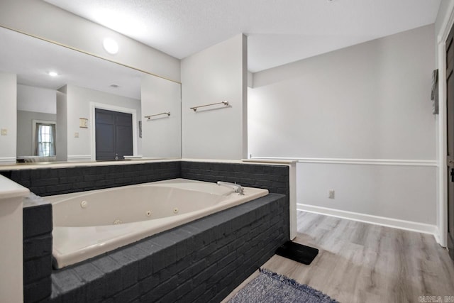 55 Laver Cir, Little Rock, AR 72210 - full bathroom featuring a whirlpool tub, wood finished floors, and baseboards