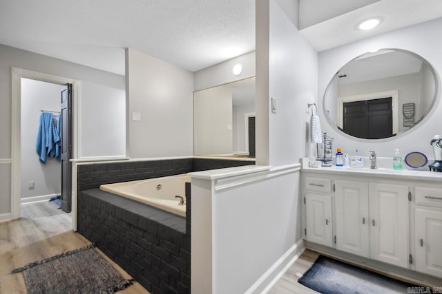55 Laver Cir, Little Rock, AR 72210 - full bathroom with wood finished floors, vanity, a bath, and baseboards