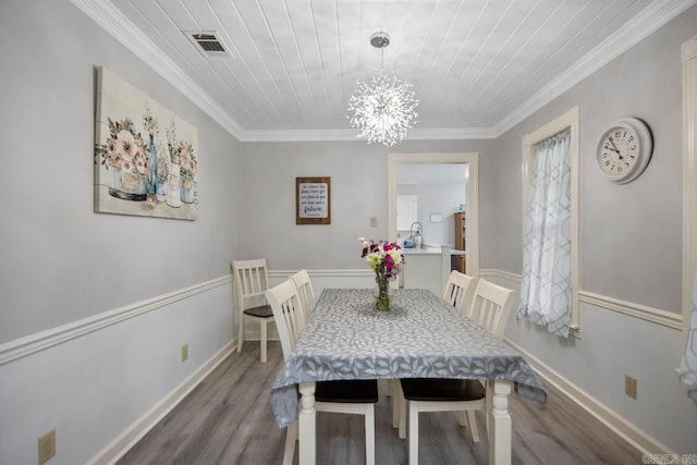 55 Laver Cir, Little Rock, AR 72210 - dining space with wood finished floors, a chandelier, ornamental molding, baseboards, and wooden ceiling