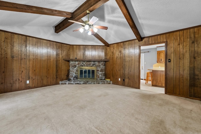 104 Heatherbrae Ct, Sherwood, AR 72120 - unfurnished living room featuring wooden walls, ceiling fan, light colored carpet, a fireplace, and a textured ceiling