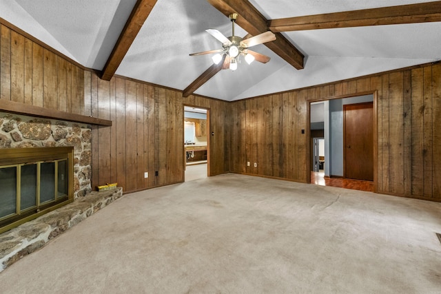 104 Heatherbrae Ct, Sherwood, AR 72120 - unfurnished living room featuring wooden walls, a ceiling fan, carpet flooring, and a stone fireplace