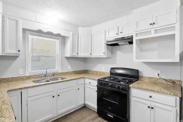 713 Hyacinth St, North Little Rock, AR 72117 - kitchen with gas stove, under cabinet range hood, a sink, open shelves, and white cabinetry