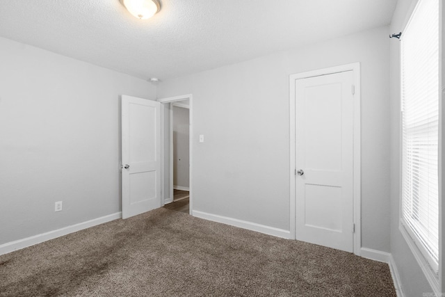 713 Hyacinth St, North Little Rock, AR 72117 - unfurnished bedroom with carpet flooring, baseboards, and a textured ceiling