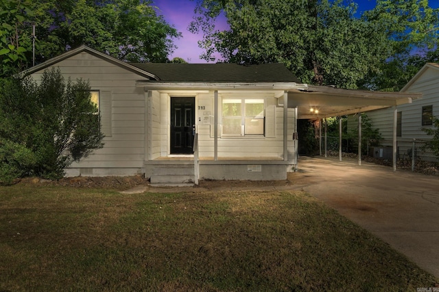713 Hyacinth St, North Little Rock, AR 72117 - view of front of home featuring concrete driveway, a front yard, and a carport