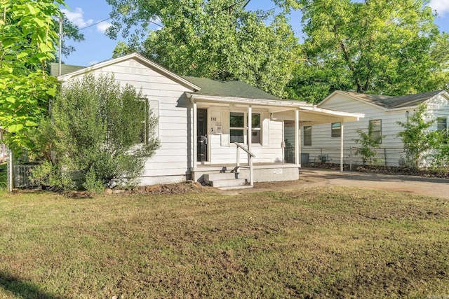 713 Hyacinth St, North Little Rock, AR 72117 - ranch-style home featuring a front yard, covered porch, concrete driveway, and an attached carport