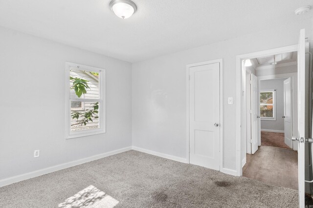 713 Hyacinth St, North Little Rock, AR 72117 - unfurnished bedroom featuring carpet floors, attic access, and baseboards