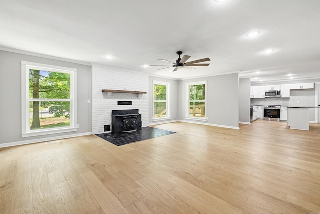 912 Bumpus Rd, Alexander, AR 72002 - unfurnished living room featuring ceiling fan, baseboards, ornamental molding, light wood finished floors, and recessed lighting