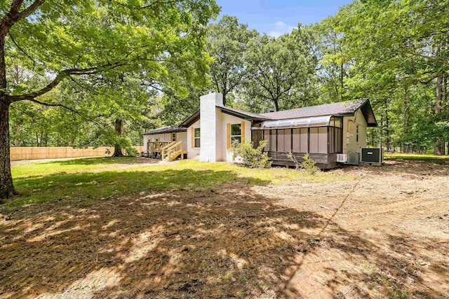 912 Bumpus Rd, Alexander, AR 72002 - back of house with a sunroom and a chimney
