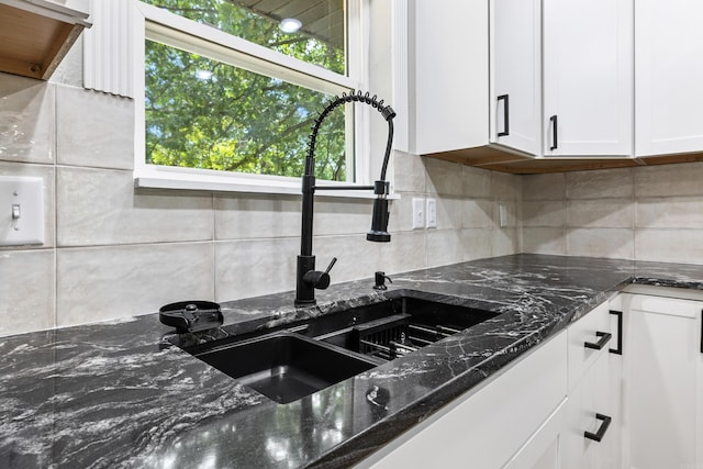 912 Bumpus Rd, Alexander, AR 72002 - kitchen featuring a sink, white cabinetry, decorative backsplash, and dark stone countertops