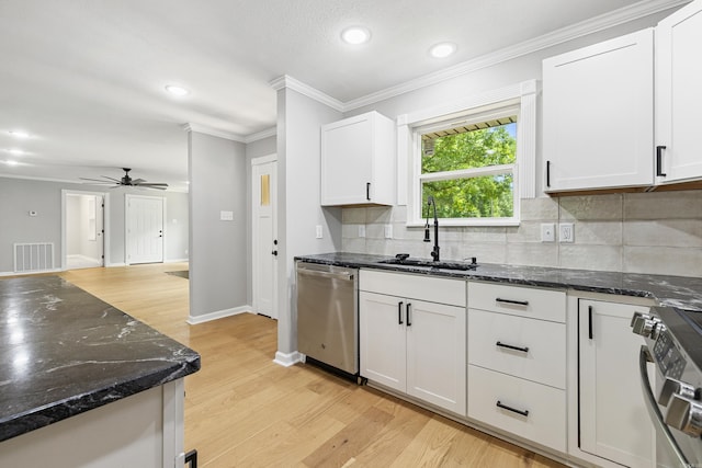 912 Bumpus Rd, Alexander, AR 72002 - kitchen with stainless steel appliances, a sink, decorative backsplash, light wood finished floors, and white cabinetry