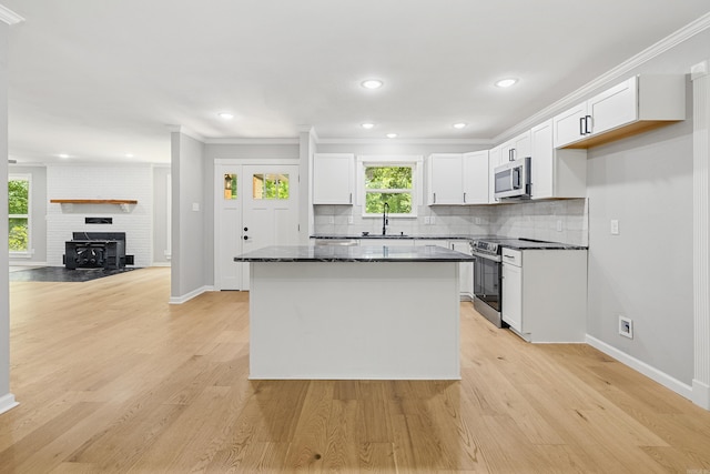 912 Bumpus Rd, Alexander, AR 72002 - kitchen featuring appliances with stainless steel finishes, a sink, white cabinetry, backsplash, and baseboards