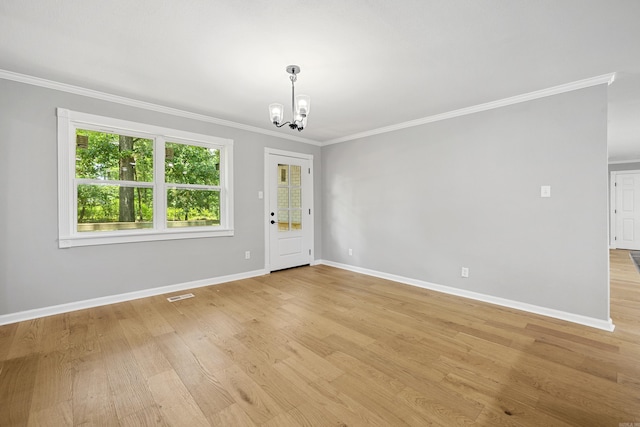 912 Bumpus Rd, Alexander, AR 72002 - unfurnished room with a chandelier, crown molding, baseboards, and light wood-style floors