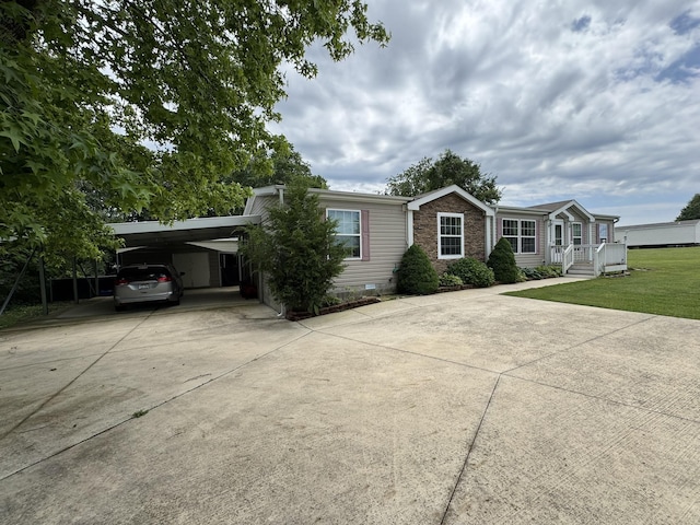 684 Cotter Rd, Gassville, AR 72635 - view of front of property featuring concrete driveway, a carport, a front yard, and brick siding