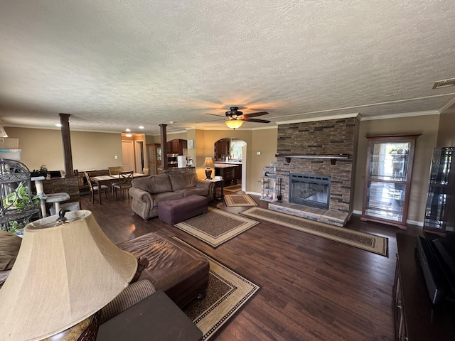 684 Cotter Rd, Gassville, AR 72635 - living area with a ceiling fan, a fireplace, ornamental molding, wood finished floors, and a textured ceiling