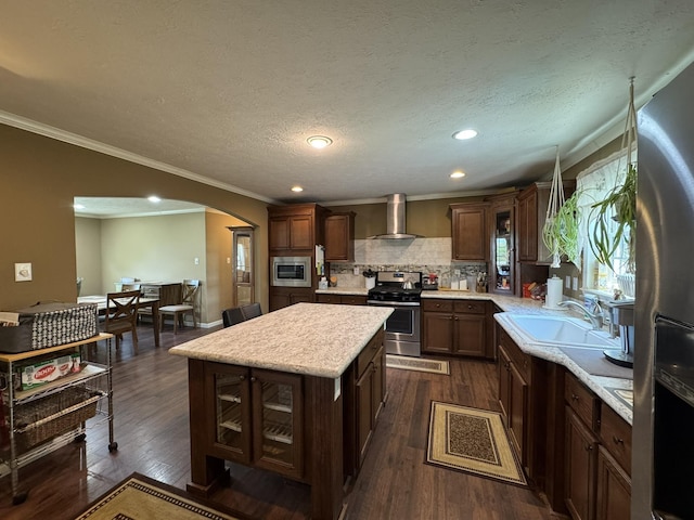 684 Cotter Rd, Gassville, AR 72635 - kitchen with stainless steel appliances, wall chimney range hood, a sink, light countertops, and a kitchen island