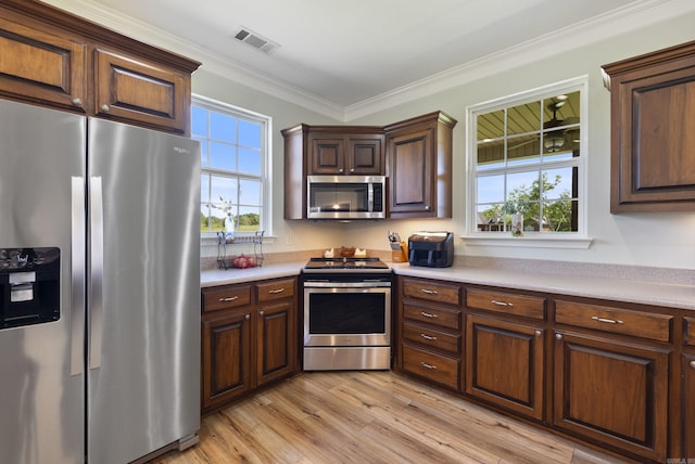 118 Caroline Loop, Plumerville, AR 72127 - kitchen featuring stainless steel appliances, light countertops, ornamental molding, and light wood finished floors