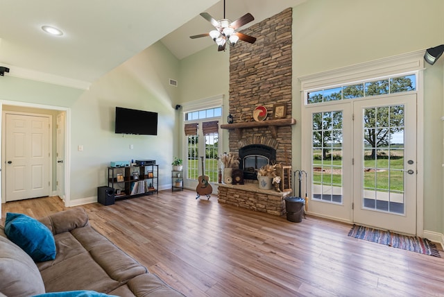 118 Caroline Loop, Plumerville, AR 72127 - living room with high vaulted ceiling, ceiling fan, wood finished floors, baseboards, and a stone fireplace