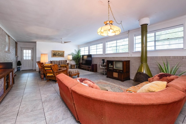 4500 Glenmere Rd, North Little Rock, AR 72116 - living room featuring brick wall, a wood stove, and a ceiling fan