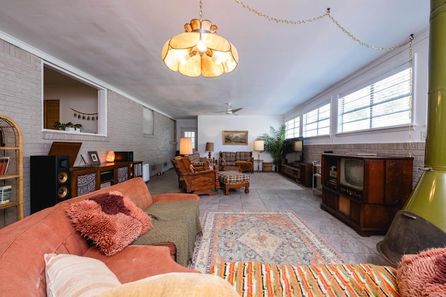 4500 Glenmere Rd, North Little Rock, AR 72116 - living room featuring brick wall, a ceiling fan, and a wood stove