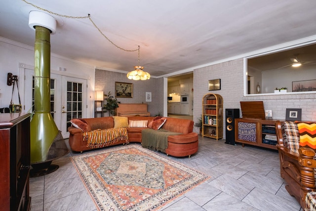 4500 Glenmere Rd, North Little Rock, AR 72116 - tiled living room featuring crown molding, french doors, and brick wall