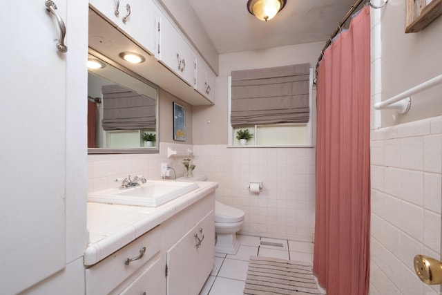 4500 Glenmere Rd, North Little Rock, AR 72116 - full bathroom featuring tile walls, vanity, toilet, tile patterned floors, and wainscoting