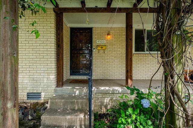 4500 Glenmere Rd, North Little Rock, AR 72116 - view of exterior entry with covered porch, brick siding, and crawl space