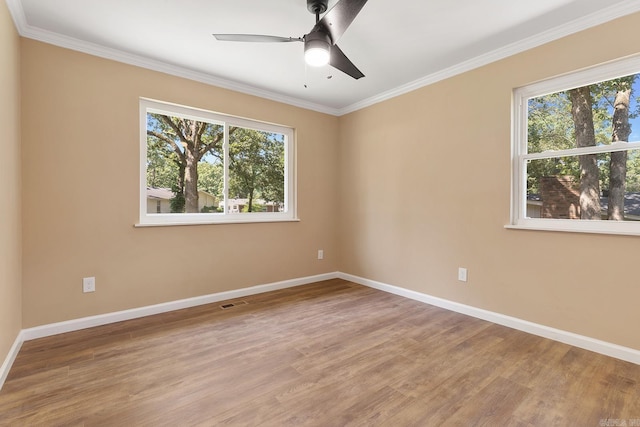 6513 Corsica Dr, North Little Rock, AR 72116 - empty room featuring plenty of natural light, wood finished floors, baseboards, and crown molding
