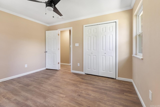 6513 Corsica Dr, North Little Rock, AR 72116 - unfurnished bedroom featuring crown molding, wood finished floors, baseboards, a closet, and a ceiling fan