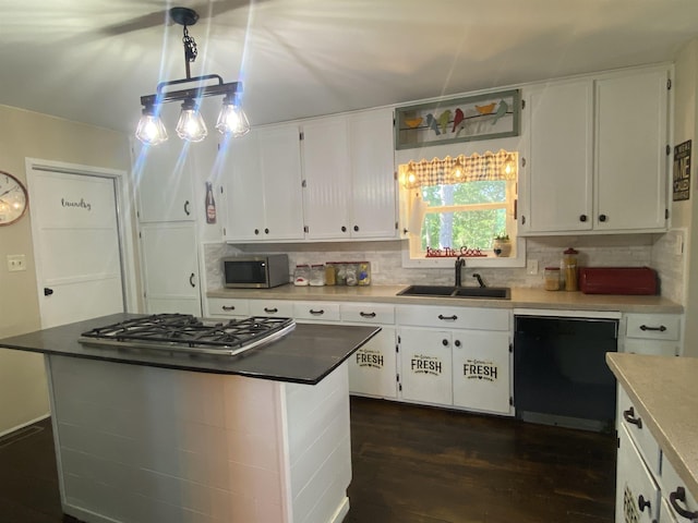 16 Mockingbird Ln, Story, AR 71970 - kitchen with appliances with stainless steel finishes, a sink, dark wood-style flooring, white cabinets, and tasteful backsplash