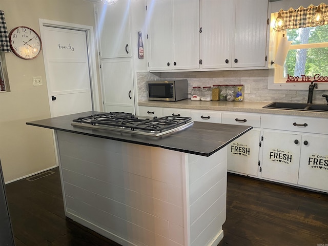 16 Mockingbird Ln, Story, AR 71970 - kitchen featuring stainless steel appliances, a sink, white cabinetry, and decorative backsplash