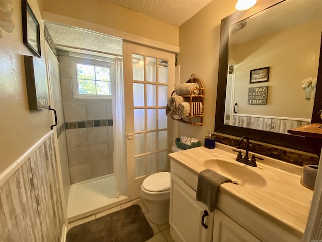 16 Mockingbird Ln, Story, AR 71970 - bathroom featuring vanity, a shower stall, toilet, a textured ceiling, and tile patterned floors