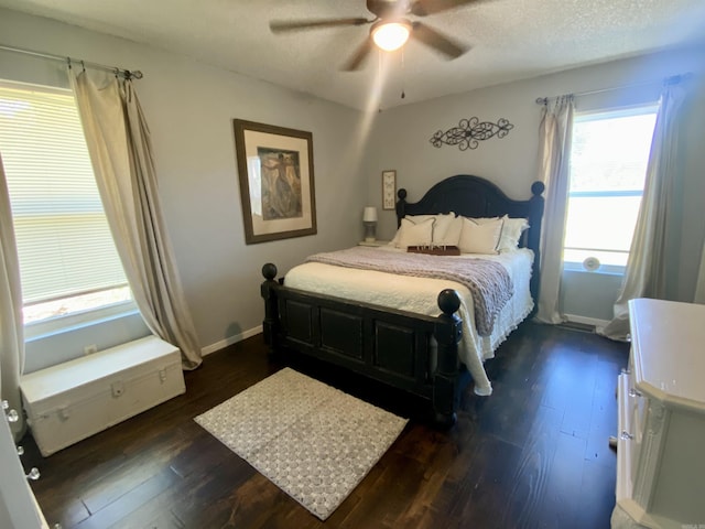 16 Mockingbird Ln, Story, AR 71970 - bedroom with dark wood-style flooring, ceiling fan, and baseboards