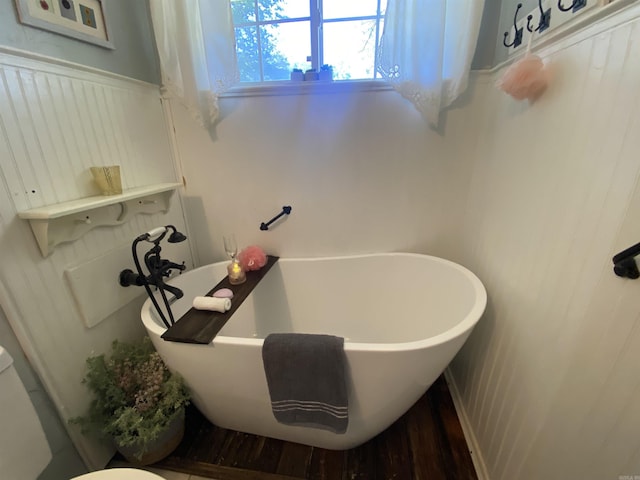 16 Mockingbird Ln, Story, AR 71970 - full bathroom featuring a freestanding bath and wood finished floors