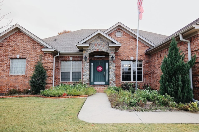 133 Scenic Valley Loop, Maumelle, AR 72113 - view of front of home with brick siding, a front yard, and roof with shingles